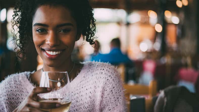 Black woman drinking wine
