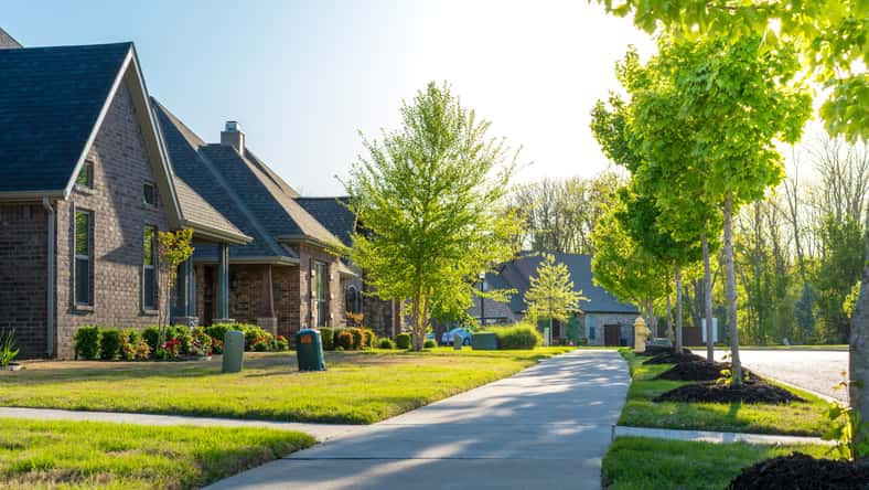 View of modern residential houses neighborhood street in Bentonville, Northwest Arkansas, sunny flare day, fast growing city lifestyle