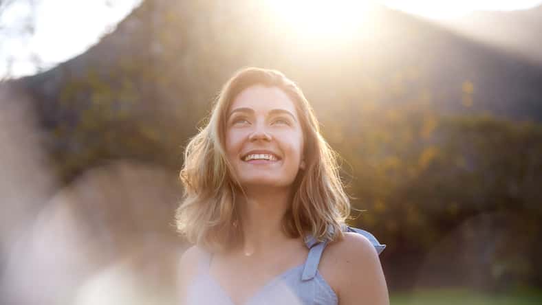 happy sunrise woman with beautiful smile full of optimism