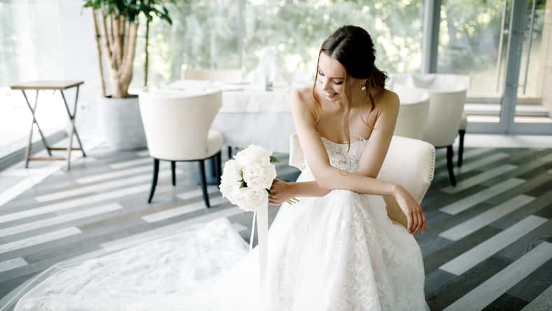 Beautiful bride wearing a fashion wedding dress in a beautiful restaurant