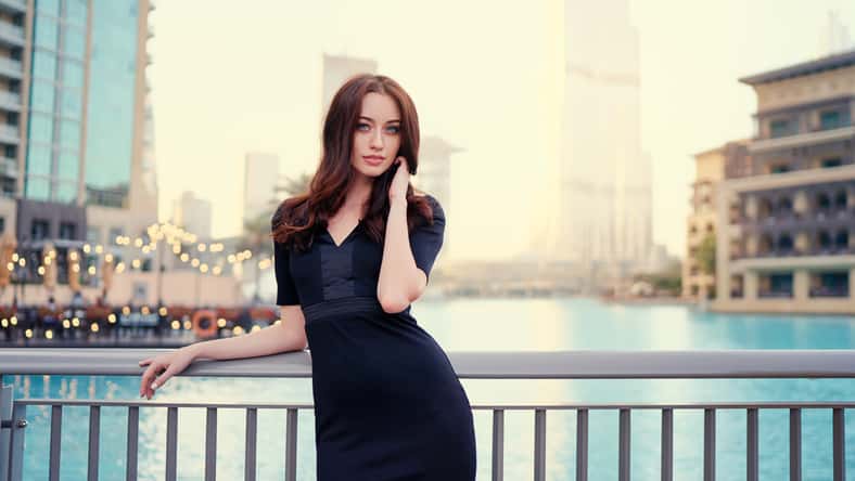 Portrait of beautiful caucasian woman with charming smile and long hair walking on the Dubai street.