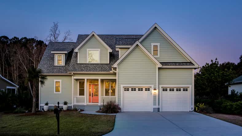 Front elevation of beautiful home lit up at twilight.