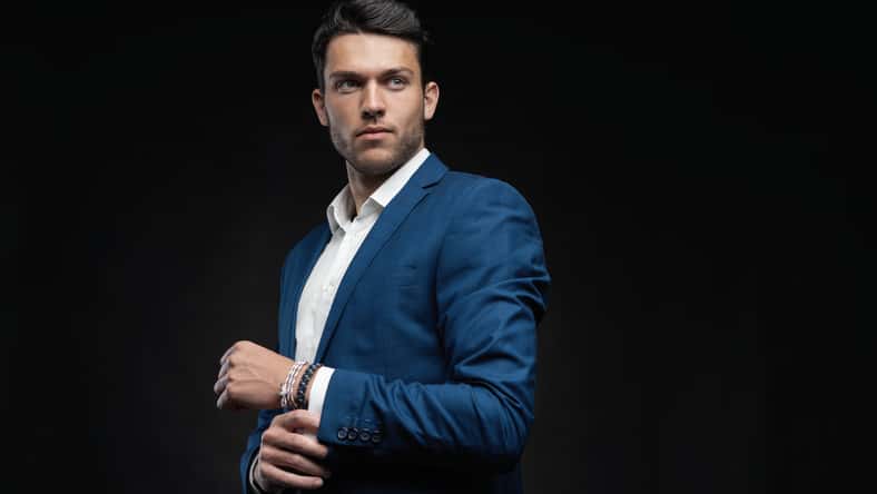 Handsome man wear blue suit isolated on black background