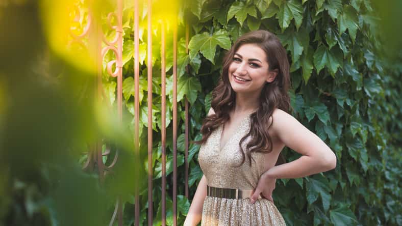 Beautiful teen girl in glamorous golden dress. Prom fashion