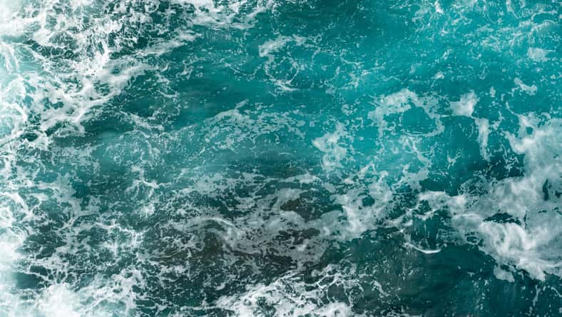 Sea foam and waves aerial overhead