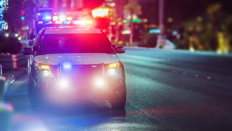 Sport Utility Vehicle Police Cruiser Emergency Assistance on the City Street. Police Car with Flashing Lights.