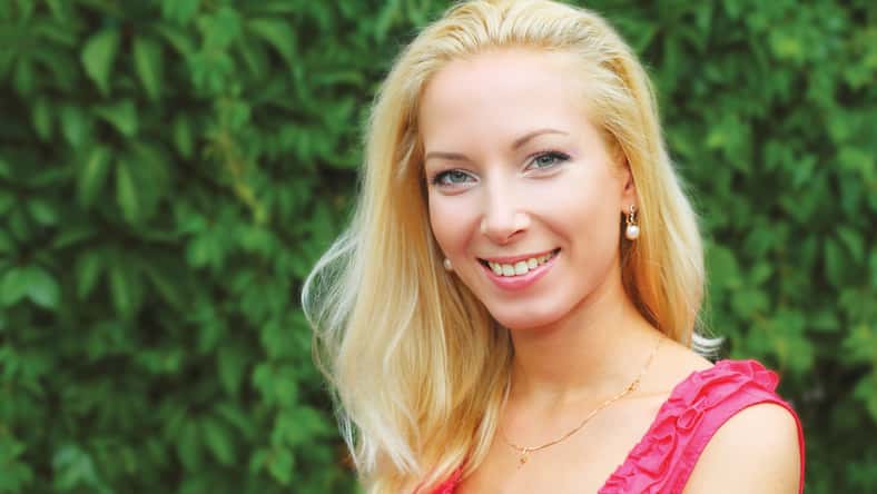 Portrait of young pretty blond woman outdoors