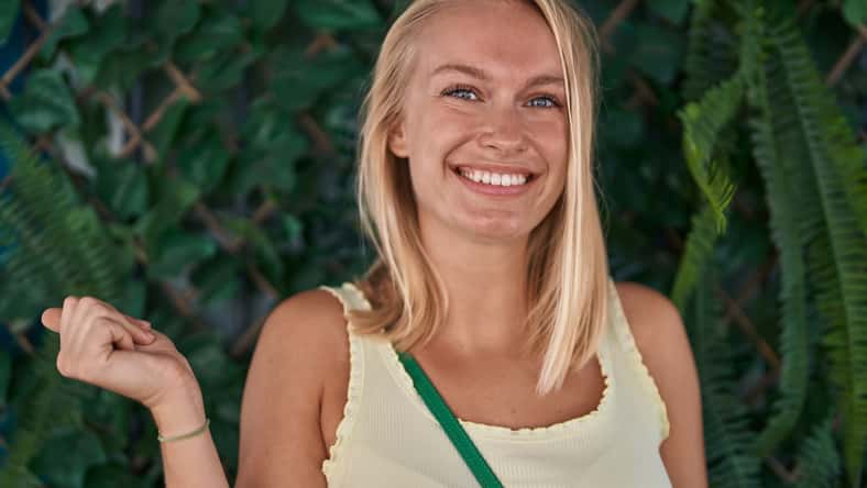 Young caucasian woman standing outdoors screaming proud, celebrating victory and success very excited with raised arm