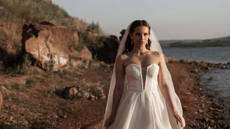 bride standing on a beach