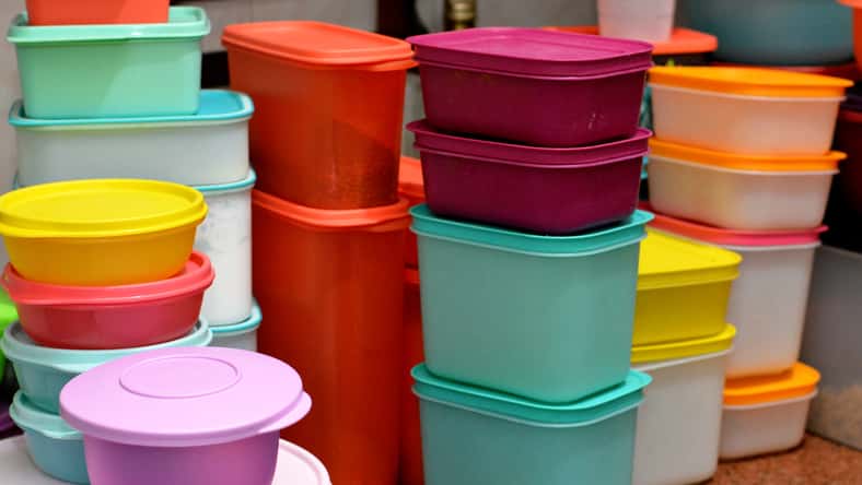 pile of several and many Tupperware plastic products, Tupperware Corporation, an American multinational company produces plastic food storage containers and bottles