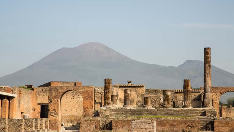 Ancient walls in Pompeii with volcano Vesuvius in the background