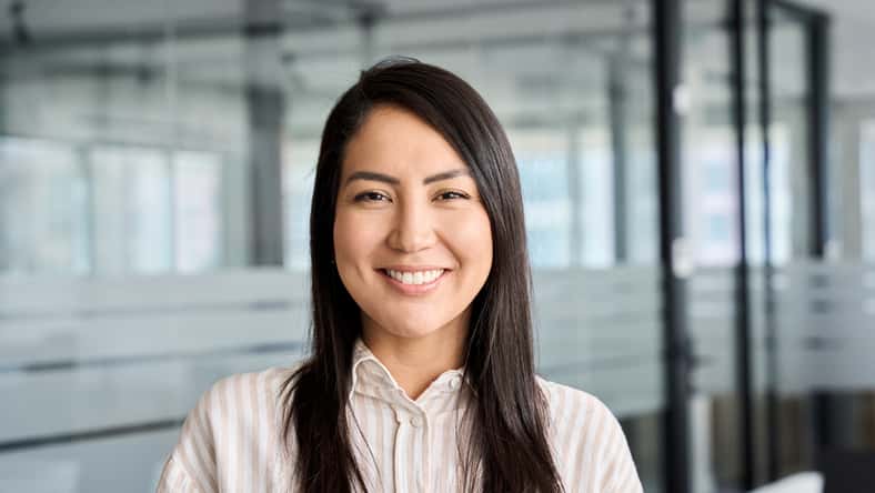 Confident smiling young professional Asian business woman corporate leader, happy japanese female employee, company sales marketing manager, standing in office, headshot portrait.