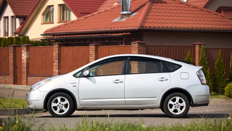 Toyota Prius XW20 2009 hybrid electric car over out of focus rural background left side view