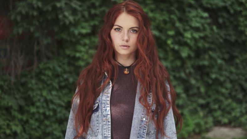 closeup portrait of as beautiful redhead girl with a sly smile