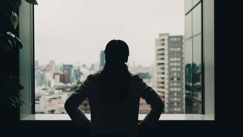 Back, thinking and window with business woman and Japan view for idea, reflection and corporate venture. Vision silhouette and memory with person and city for future, solution and confidence.