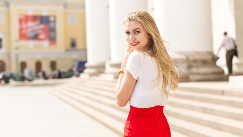 Young beautiful woman with long hair walking in city