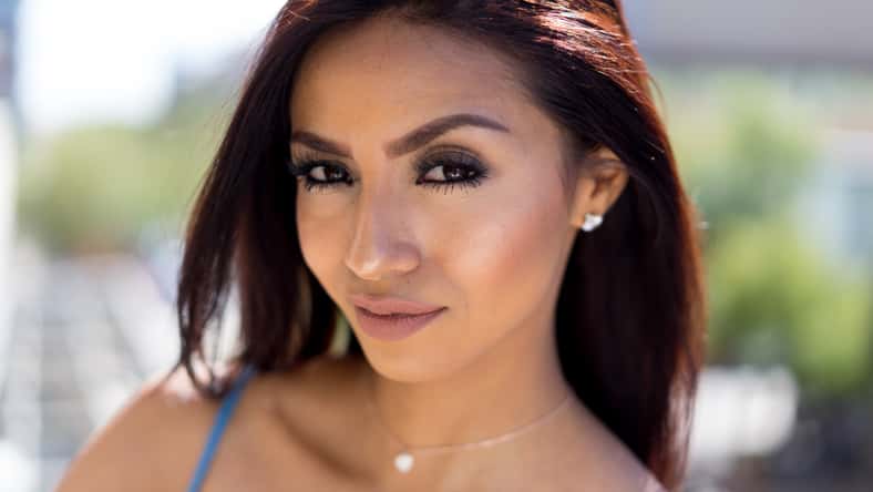 Beautiful woman with red hair outside on hot summer day