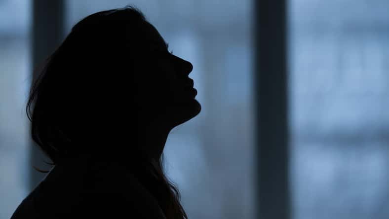 silhouette of a girl near a window