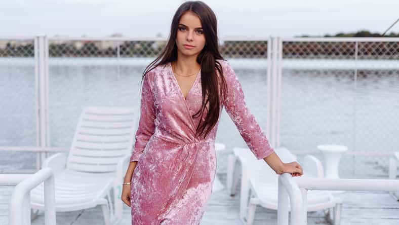 fashion portrait of happy beautiful Hispanic latino girl in purple dress with long hair