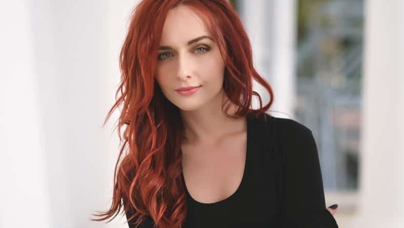Retrato de atractiva mujer joven de cabello rojo con ojos azules.