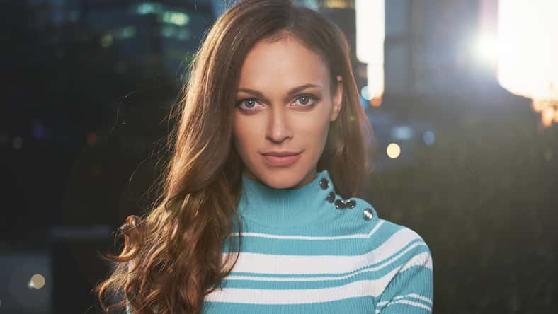 Outdoors portrait of fashionable young girl in casual clothes posing on the street. Perfect hair