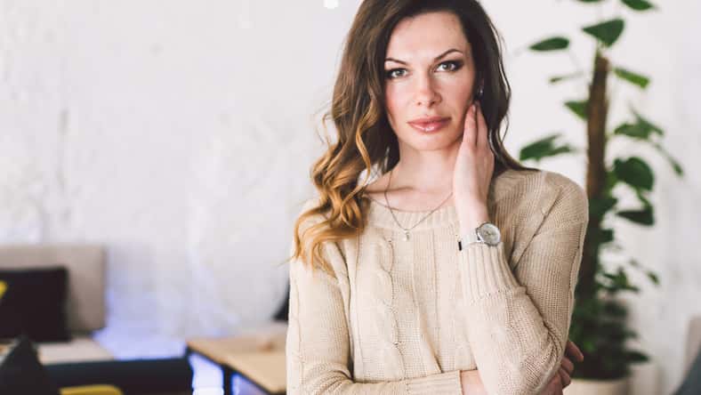 Good looking mid aged woman portrait at home. Elegant Business Woman. Middle-Aged Woman Standing In Modern Home.