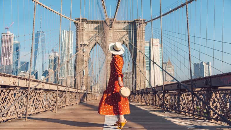 Young tourist on the Brooklyn Bridge in New York City