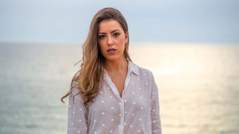 woman standing in front of a lake