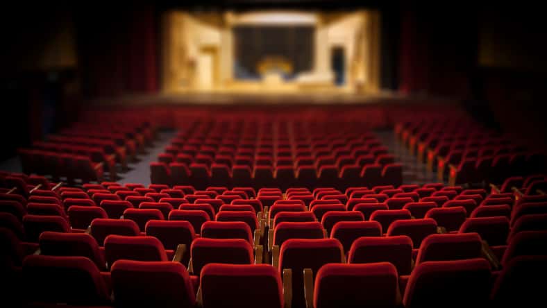 Empty red armchairs of a theater ready for a show