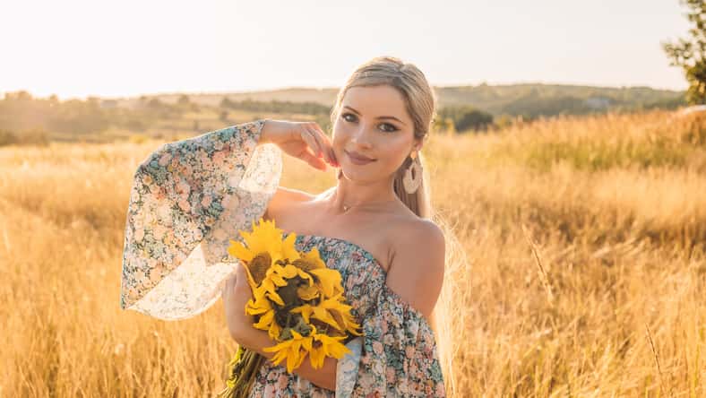portrait of beautiful happy pregnant woman in countryside during sunset