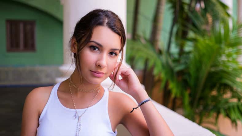 Beautiful young woman in a outdoor courtyard setting.