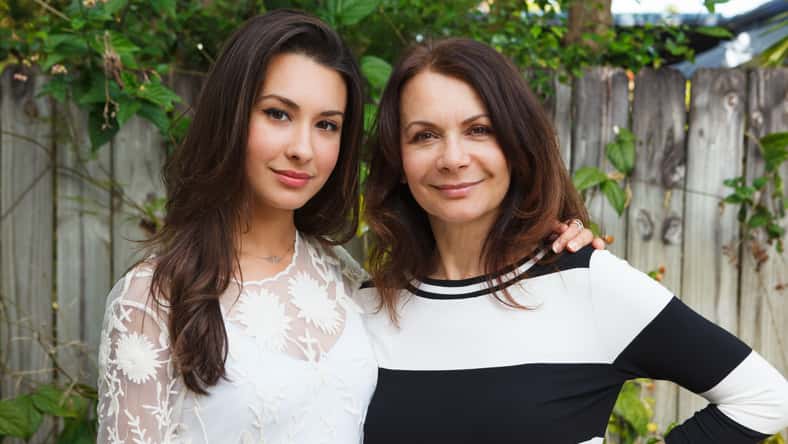 Mother and daughter portrait in a outdoor setting.
