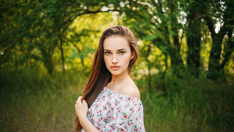 Beautiful young sensual girl with full lips. Portrait of a model on the street