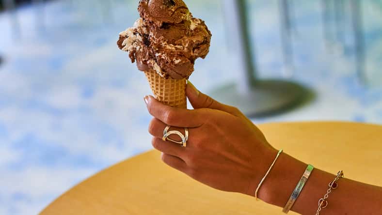 woman holding a chocolate ice cream cone
