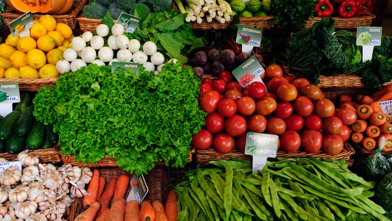 Fresh ripe vegetables on shelves in Mercado dos Lavradores, Funchal, Madeira island, Portugal.