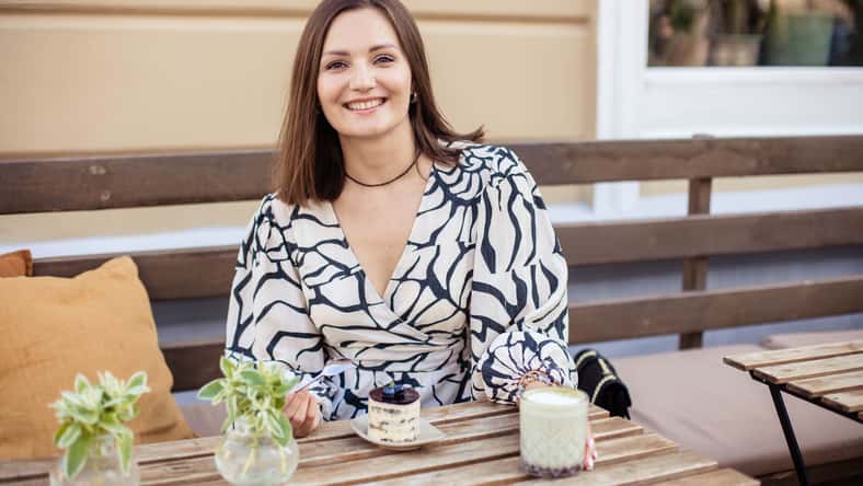 Portrait of attractive young woman in summer cafe in modern city, close-up.