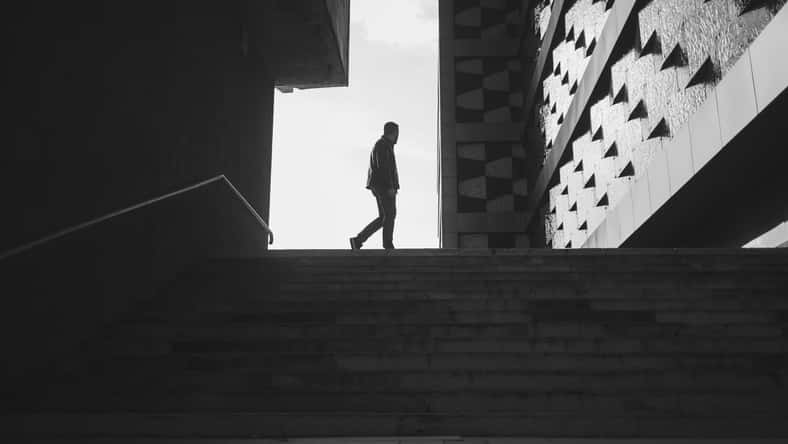 silhouette of a walking man in a city. black and white photo