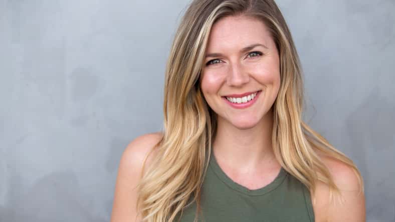Cute natural blonde woman smiling with perfect white teeth and g