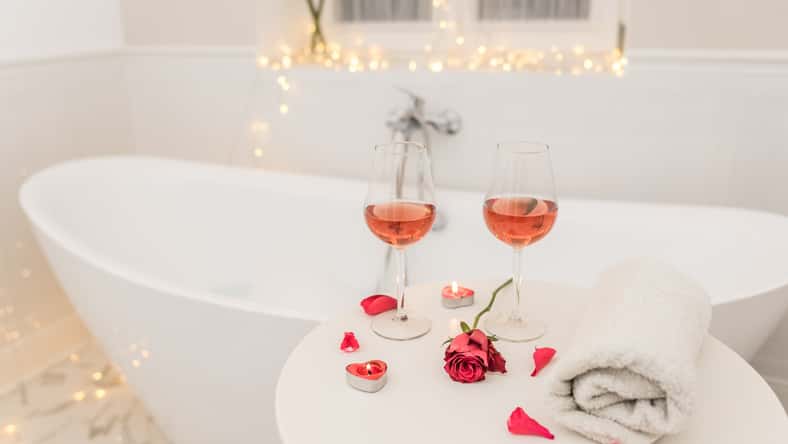 bathtub surrounded with candles, romantic atmosphere