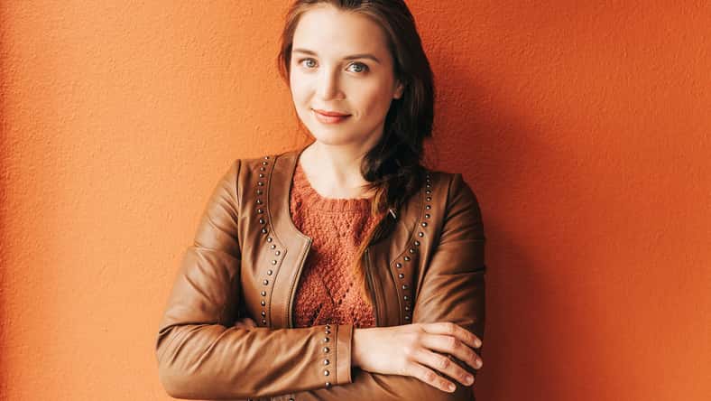 Close up portrait of beautiful young 25-30 year old woman with professional make up, wearing brown leather jacket