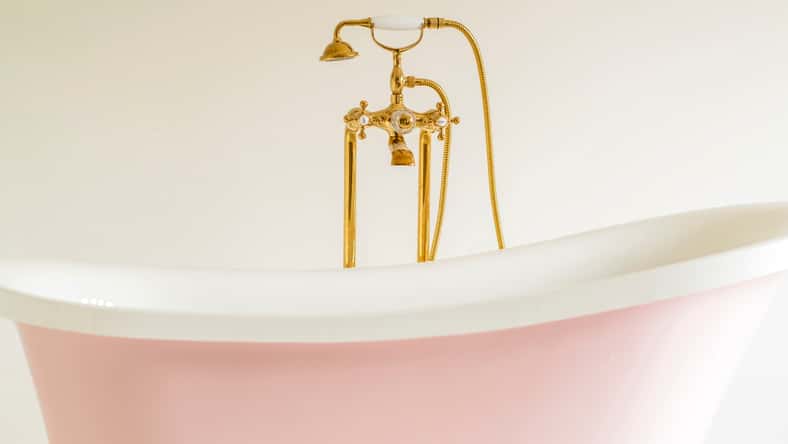 old vintage style bathroom bathtub gold steel faucet with white background