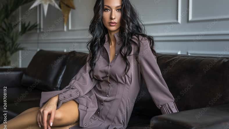 pretty brunette woman sitting on a couch