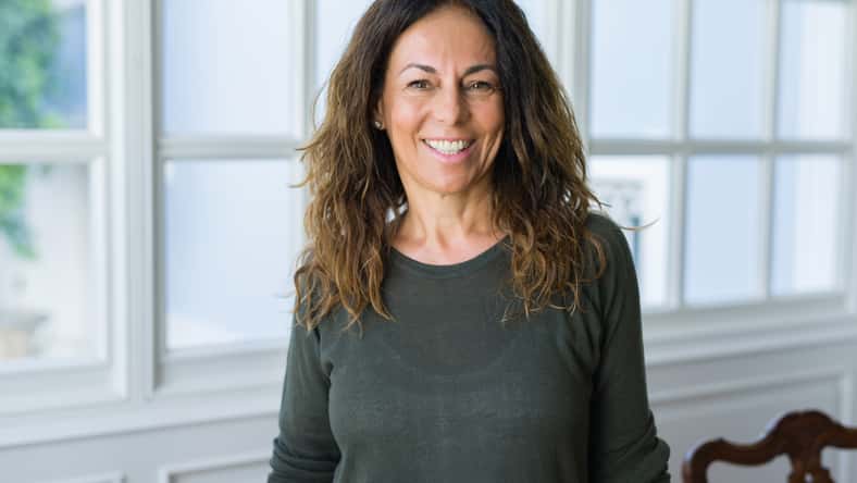 Beautiful middle age woman at home smiling cheerful