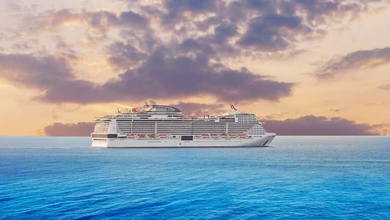 Luxury cruise ship vacation in blue azure sea sky with clouds sunset. Concept travel background.