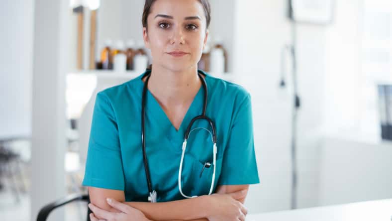 Young female doctor in medical office. Portrait of beautiful female doctor sitting in the clinic office.