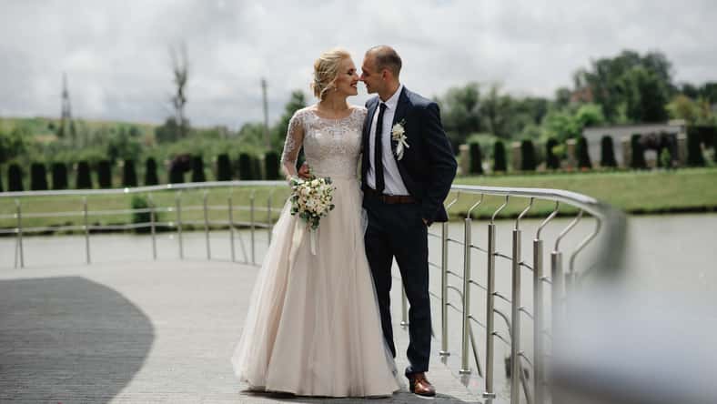 The bride and groom are hugging.