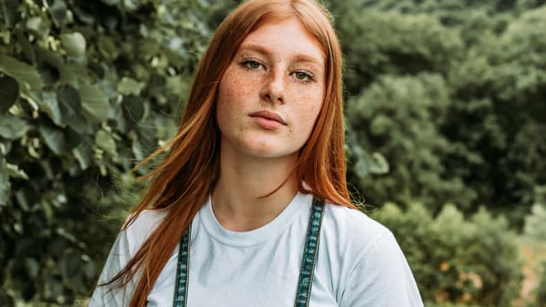 Close-up portrait of young teen freckled ginger girl