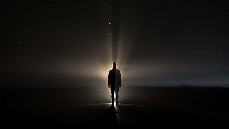 backlighting of a man in the dark of a foggy night and a light behind the model
