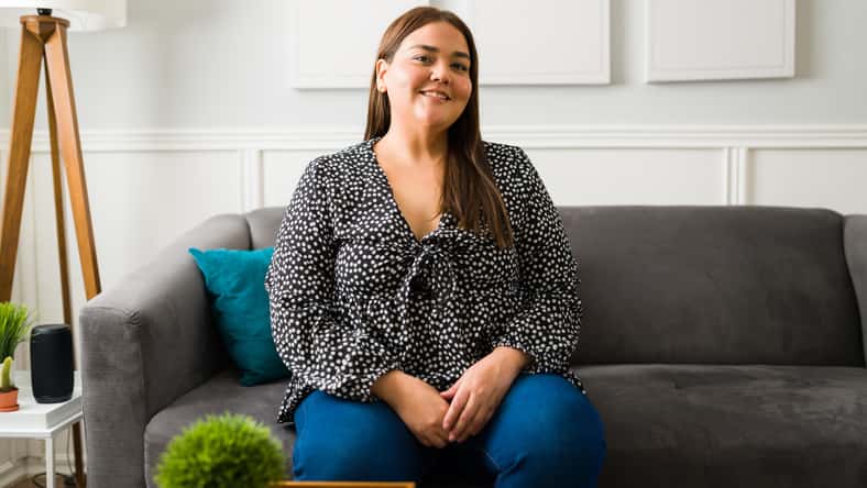 Portrait of an attractive hispanic woman with obesity smiling and feeling positive about herself