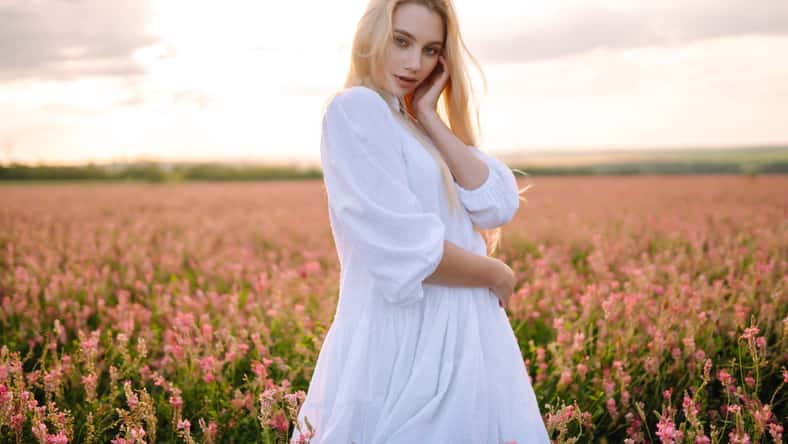 Beautiful woman in the blooming field. Nature, vacation, relax and lifestyle. Summer landscape.